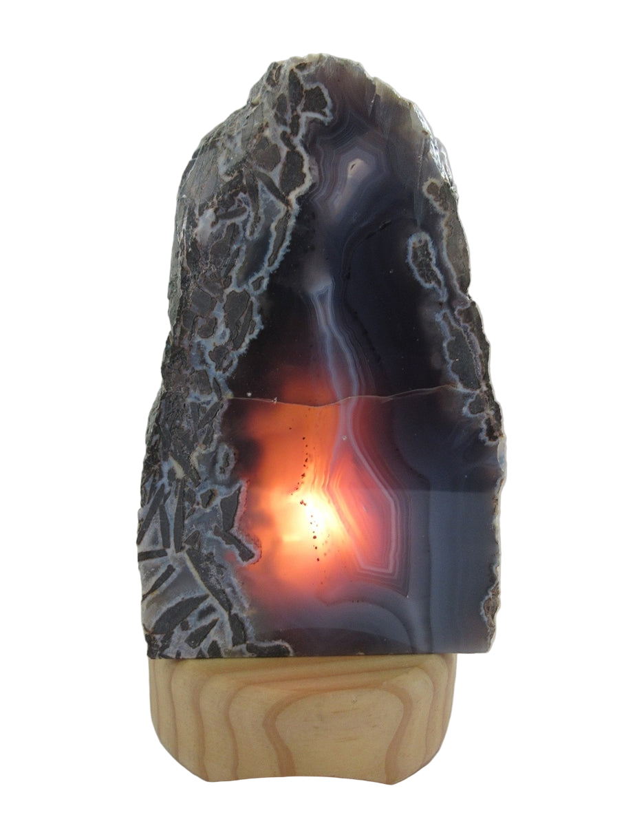 Decorative lamp made from a natural stone with a wooden base on a white background
